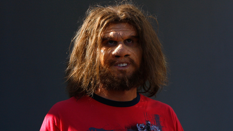 The Geico caveman in a red top