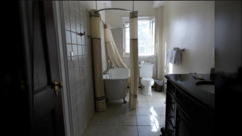 A white bathroom with a claw-footed bathtub.