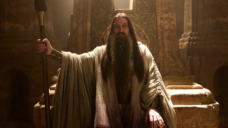 The Dark Wizard on a stone throne in "The Rings of Power"