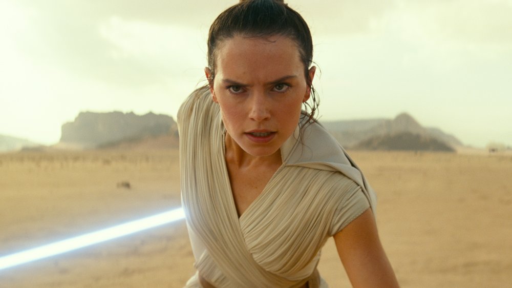 Daisy Ridley as Rey with lightsaber in The Rise of Skywalker