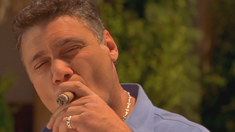 Don Eladio puffs on a cigar
