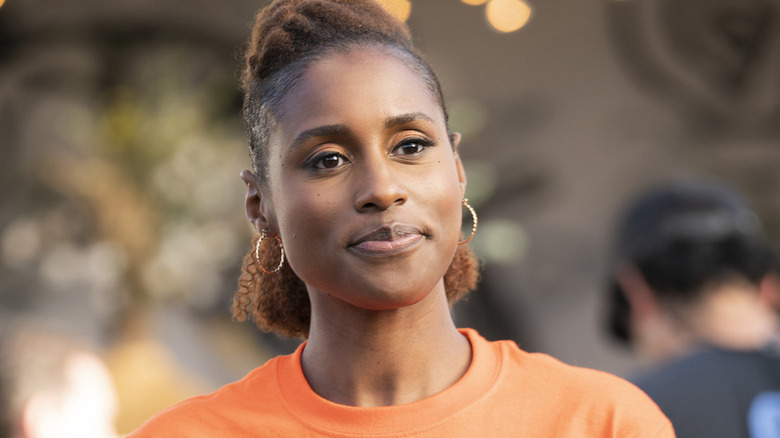 Issa Rae wearing orange T-shirt on Insecure