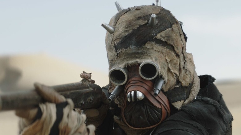 A Tusken Raider aiming their weapon in 