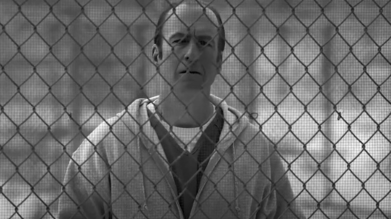 Jimmy stands behind gate 