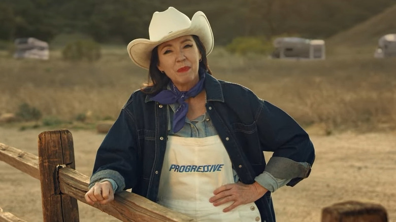 Stephanie Courtney dressed up like Flo who's dressed up like a ranch hand in a Progressive ad