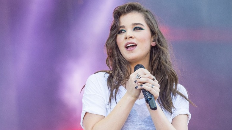 Hailee Steinfeld holding microphone on stage