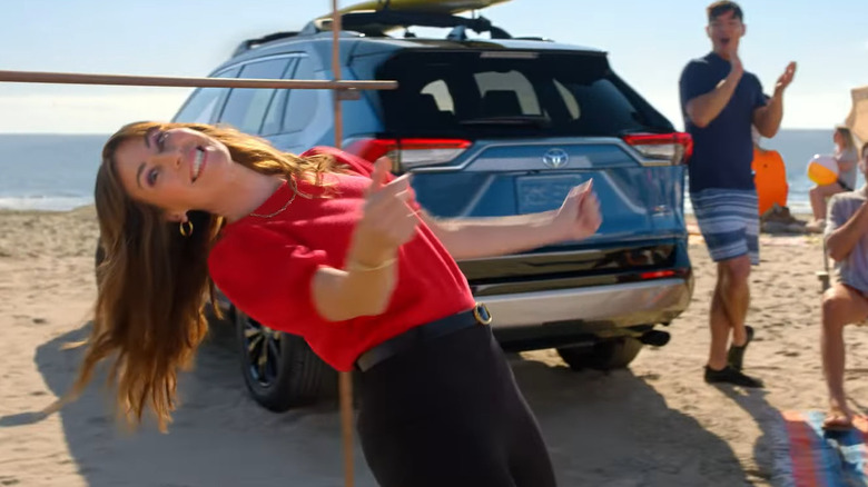 Jan from Toyota limbos in a Toyota commercial