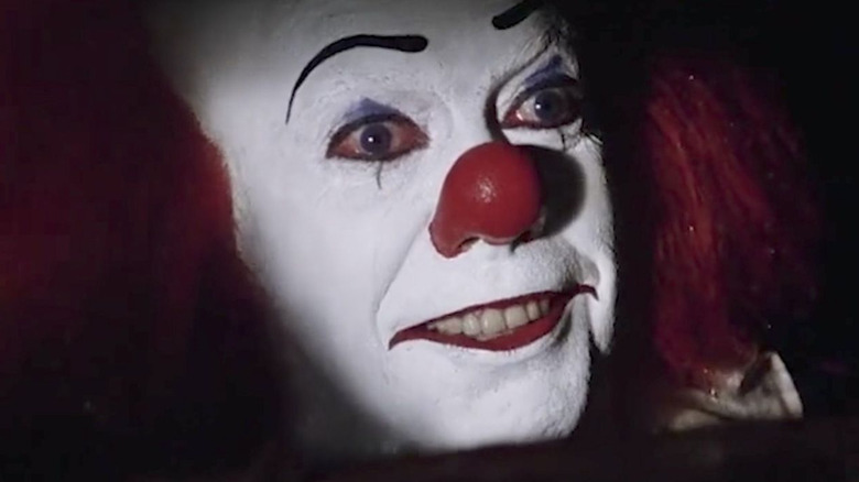 Tim Curry Pennywise smiling sewer