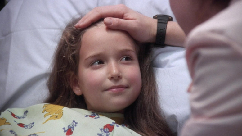 Doctor stroking young girl's head in "ER" (1995)