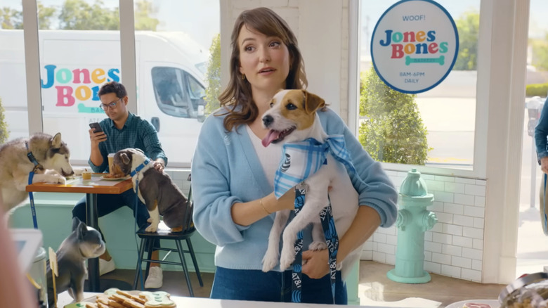 Lily holds dog in bakery