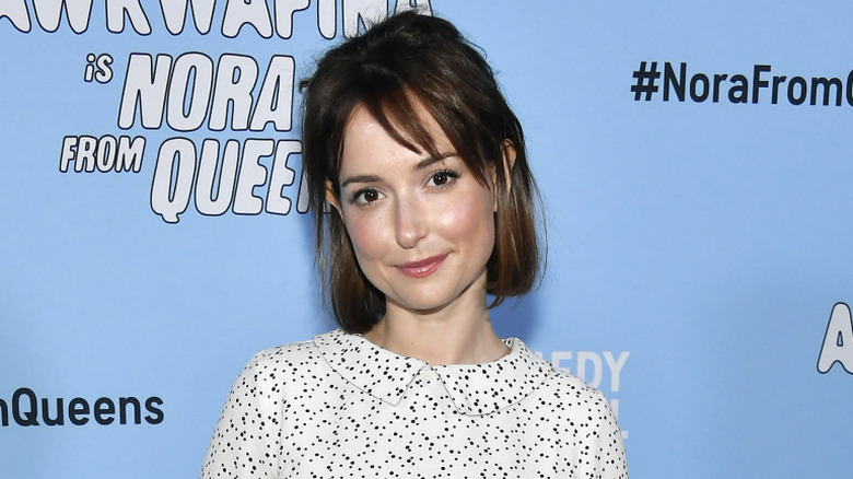 Milana Vayntrub smiling at Nora from Queens premiere