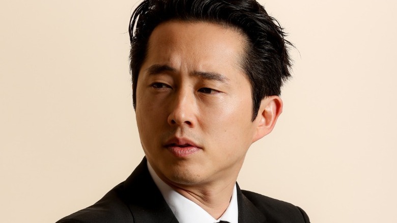Steven Yeun in jacket and shirt