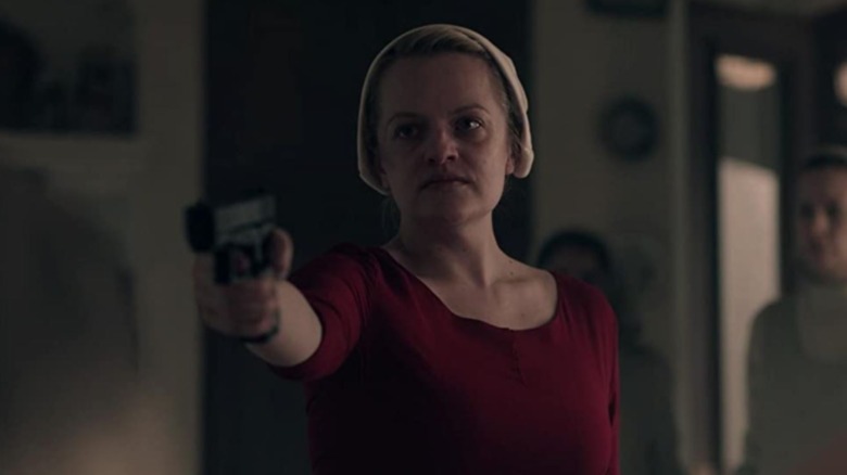 June pointing a gun