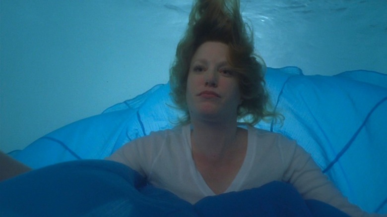 Skyler walks into the pool in a blue dress when she just can't take it anymore