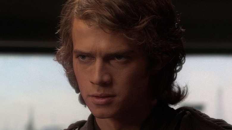 Anakin standing next to a window