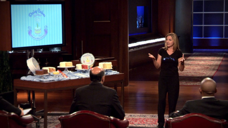 Kim Nelson talking to the sharks next to Daisy Cakes display