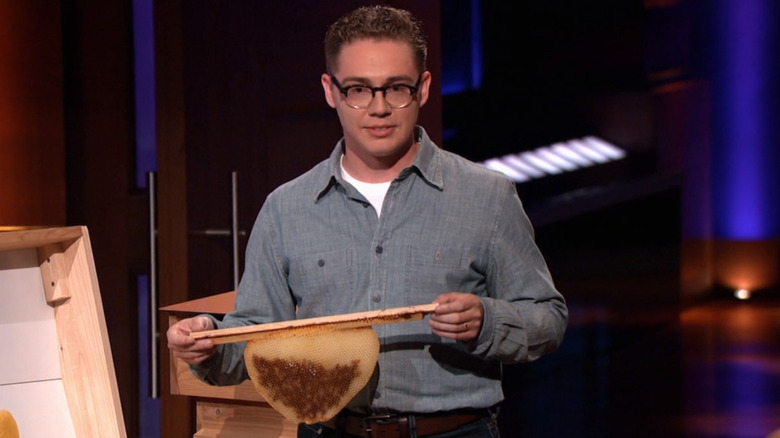 Matt Reed holding bee hive