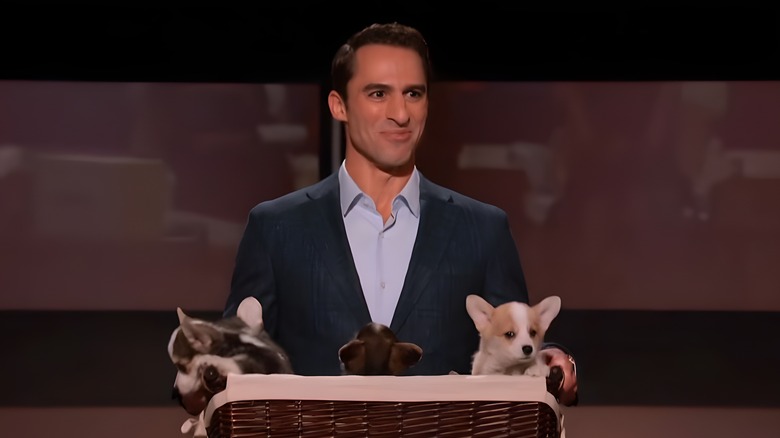 Aaron Hirschhorn holding basket of puppies
