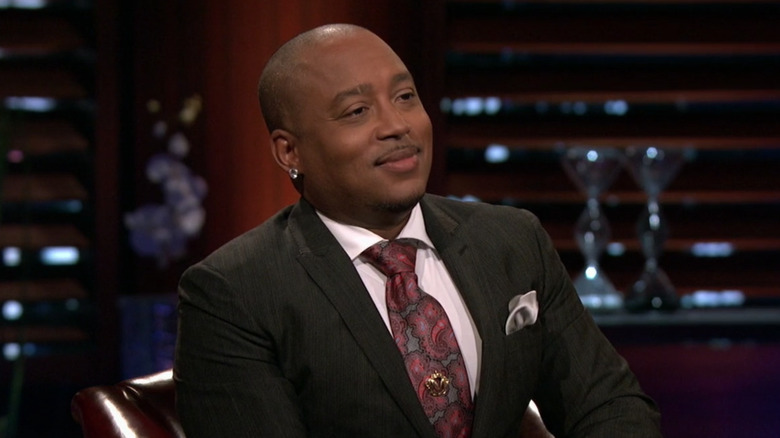 Daymond John smiling at contestant