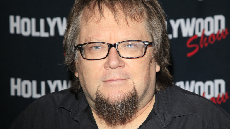 Robbie Rist poses at an event.