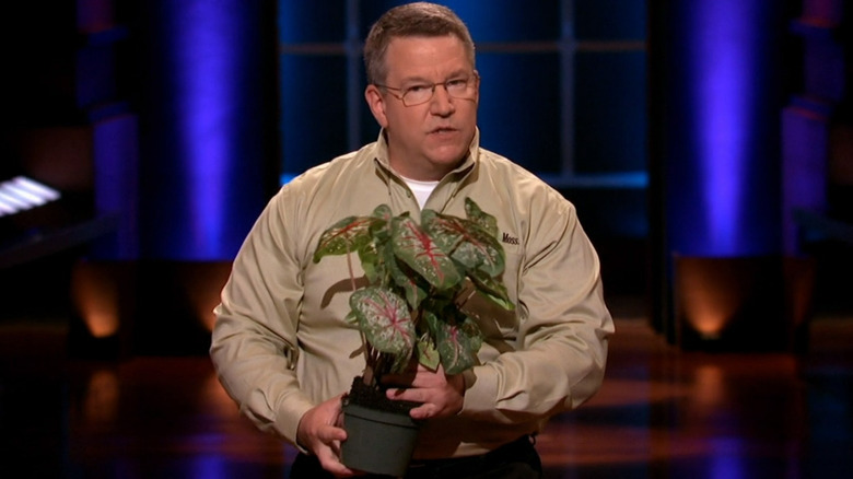 Mont Handley holding potted plant