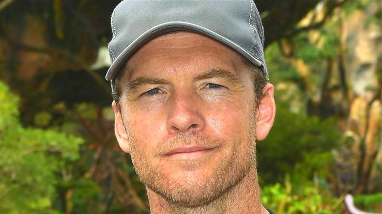 Sam Worthington wearing a gray cap