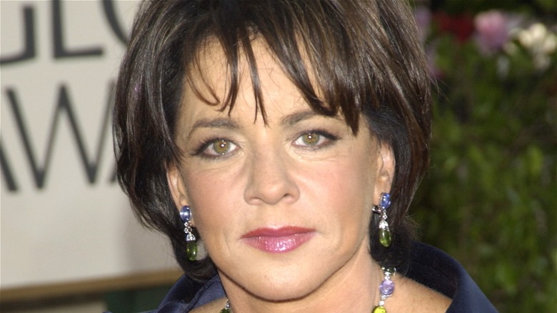 Stockard Channing wears purple and green earrings