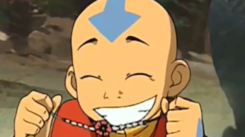 Aang holding up a necklace