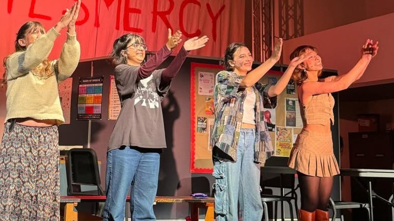 Frances Anderson performing on stage with fellow high school students