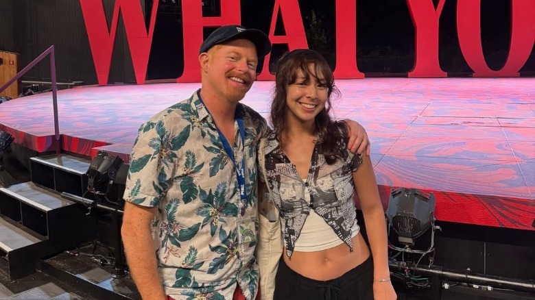 Jesse Tyler Ferguson and Frances Anderson posing for a picture together in front of a stage