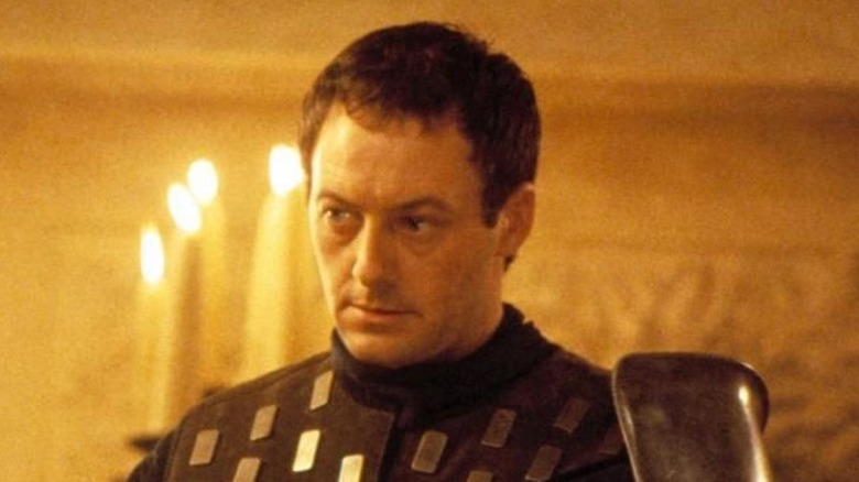 Liam Cunningham looks off screen