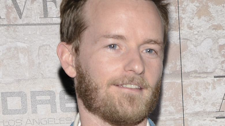 Christopher Masterson smiling slightly