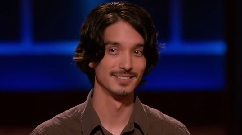 Ryan Frayne smiling against a blue backdrop