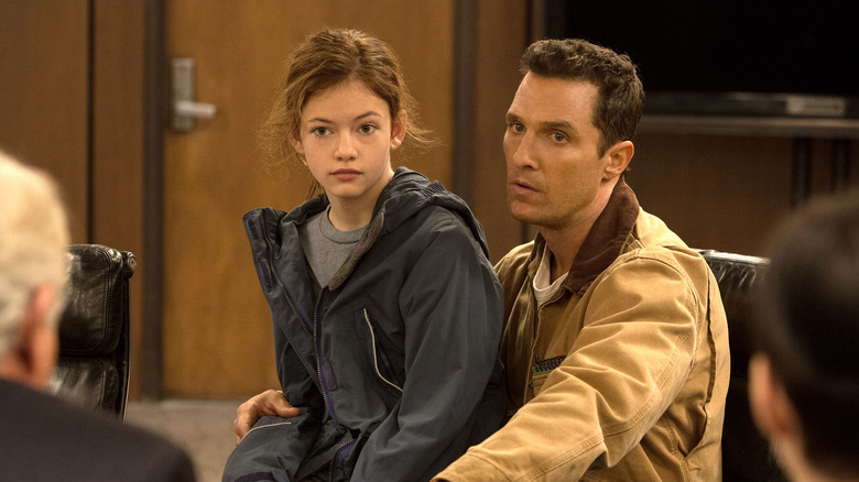 Murph sitting on her father's lap in a meeting in Interstellar (2014)