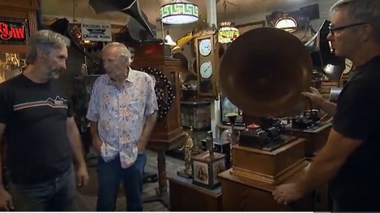 Robbie Wolfe next to an antique phonograph