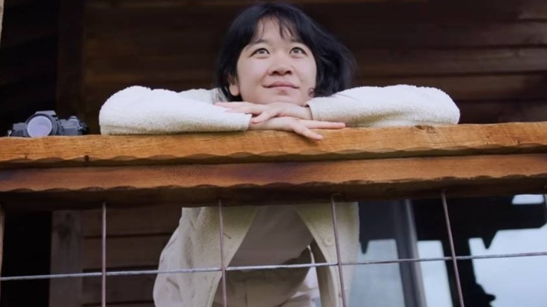 Woman leaning on Airbnb porch