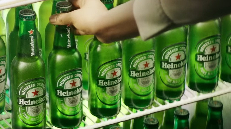 Hand grabbing Heineken bottle
