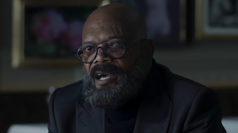 Nick Fury wearing glasses and black blazer