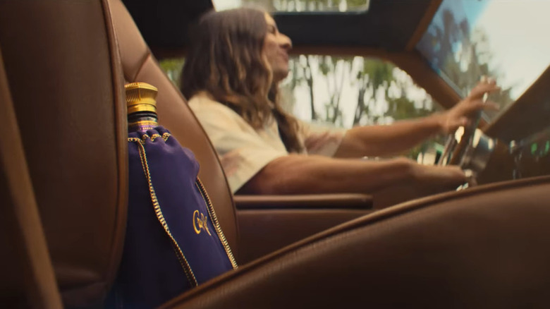 Woman driving next to Crown Royal