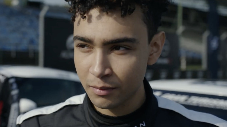 Jann Mardenborough wearing black and white racing uniform