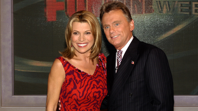 Vanna White and Pat Sajak by Wheel of Fortune display 