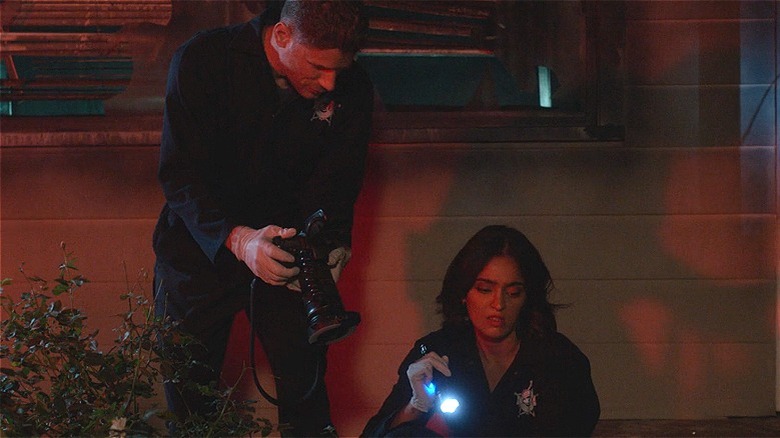 Josh Folsom taking a crime scene picture 