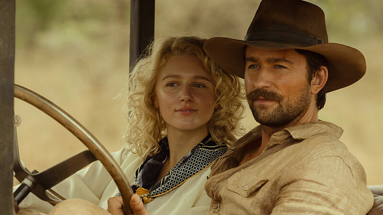 Brandon Sklenar and Julia Schlaepfer sit in car