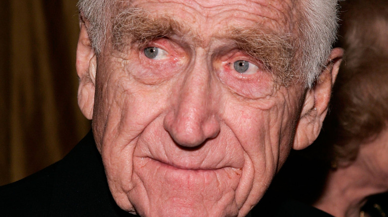 James Whitmore smiles