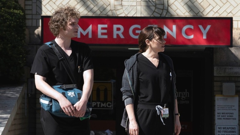 Ogilvie and Dr. McKay standing outside the entrance to the emergency room in "The Pitt."