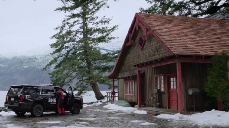 Harry's cabin and a police SUV in "Resident Alien"