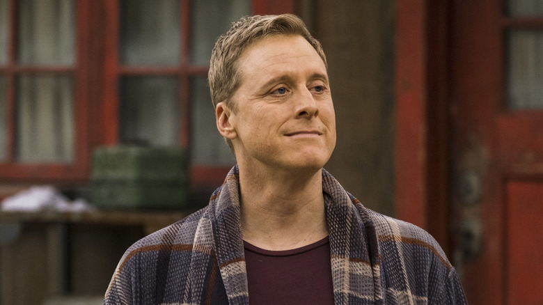 Harry smiling outside of house in 