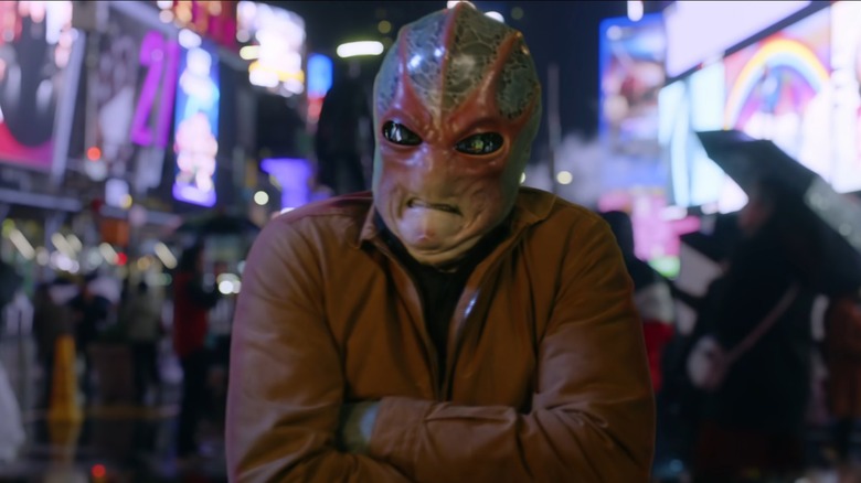 Alien Harry crossing his arms in Times Square in "Resident Alien"