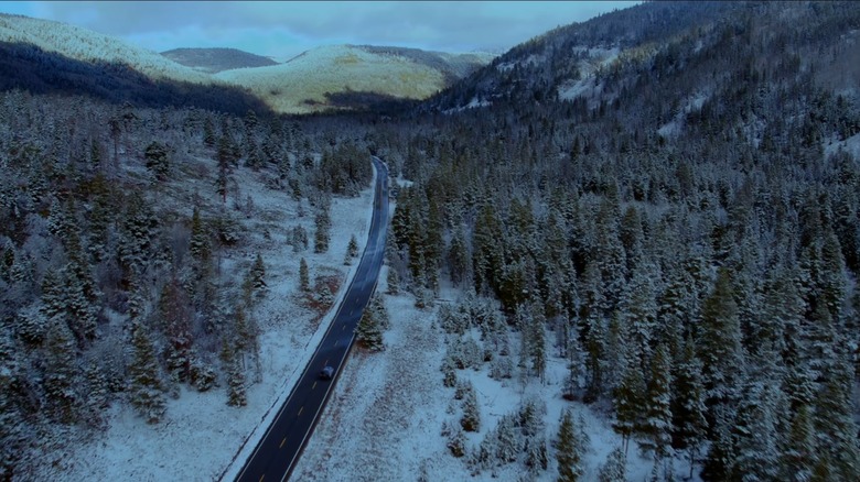 A car driving down an icy road road in "Resident Alien"