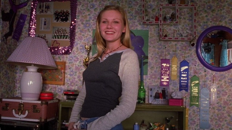 Amber Atkins in her bedroom surrounded by photos and ribbons in Drop Dead Gorgeous